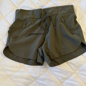 Women’s olive green athletic shorts, size small, zippered pockets